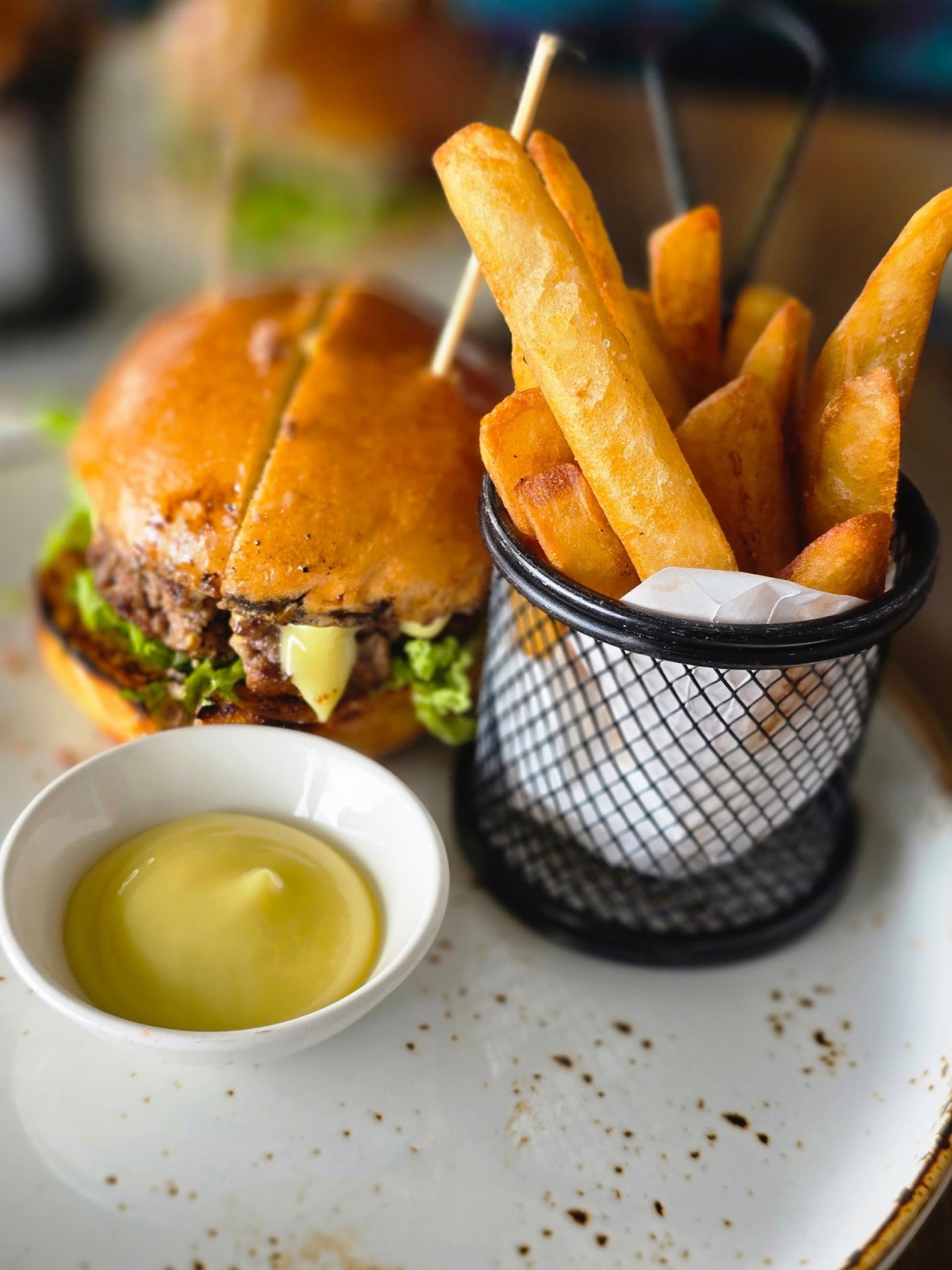 A house burger with a basket of thick-cut fries and dip