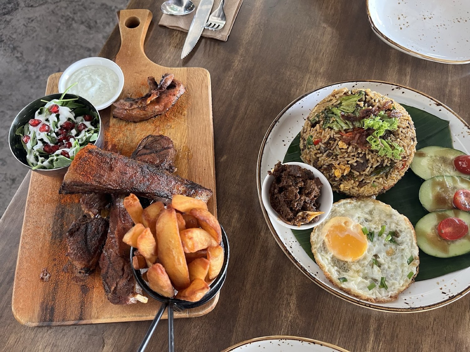 Grilled meat platter with chunky fries and a side of fried rice