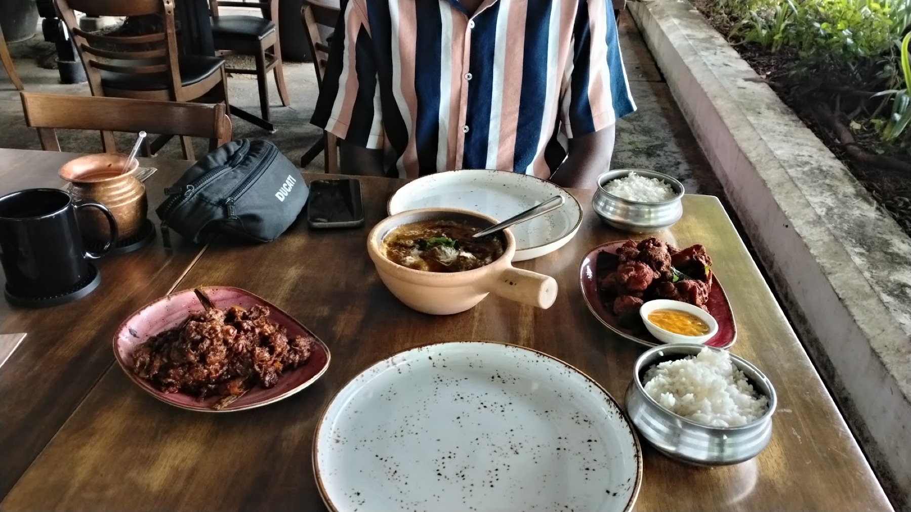 Boneless mutton varuval served with rice and side dishes