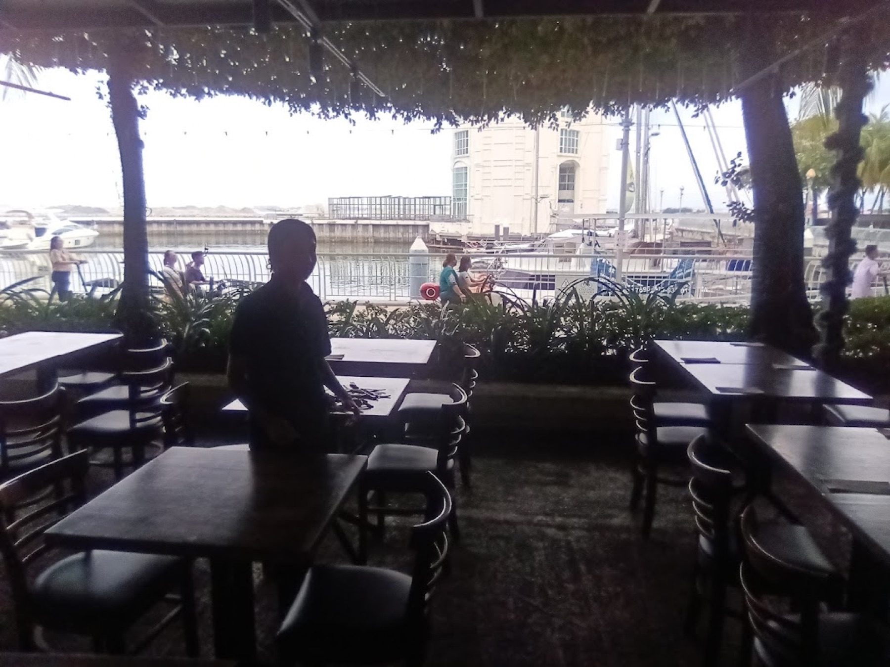 Waterside dining tables at Straits Quay marina, boats moored across the water